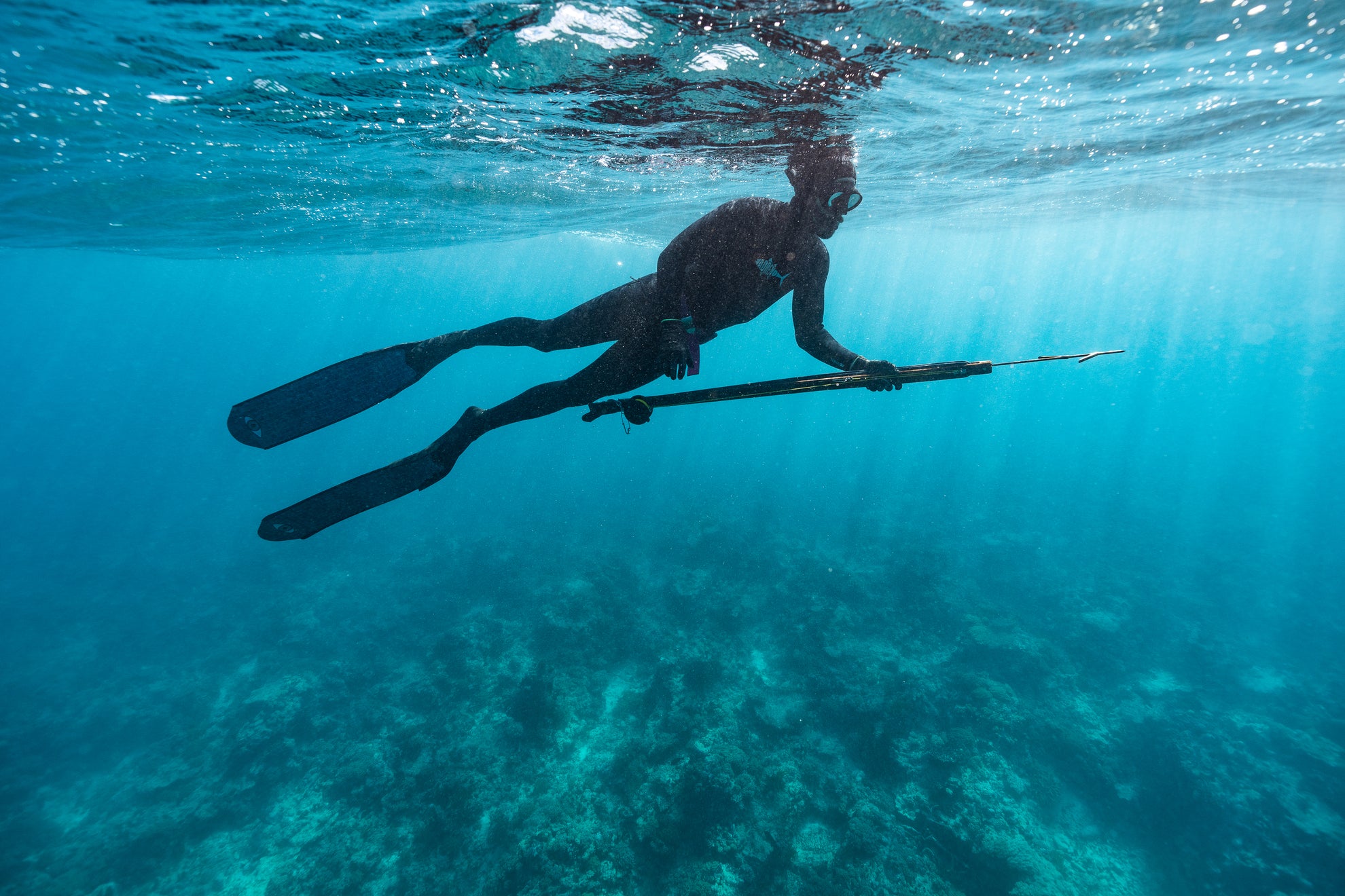 Spearfisher diving in Australian ocean conditions