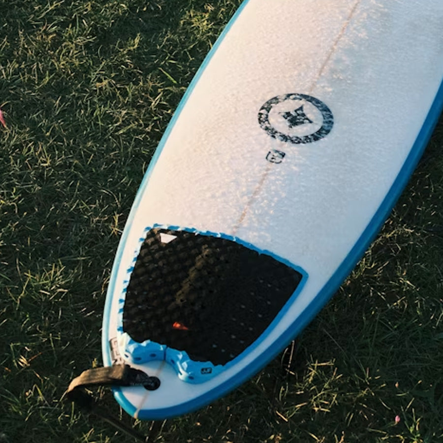 Surfboard tail pads